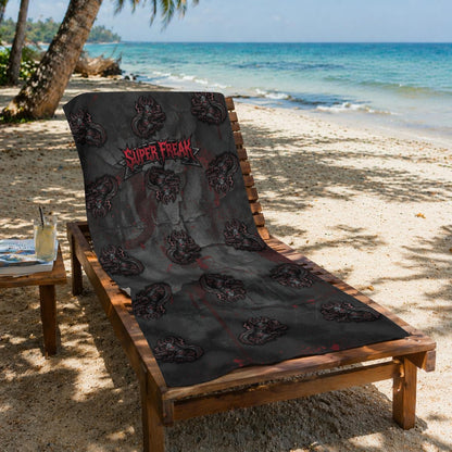Beach Towel featuring repeat pattern of creepy mascot. Featured front-left  rotated view. Draped over a wooden folding beach lounger, ready for sunbathing or drying off.
